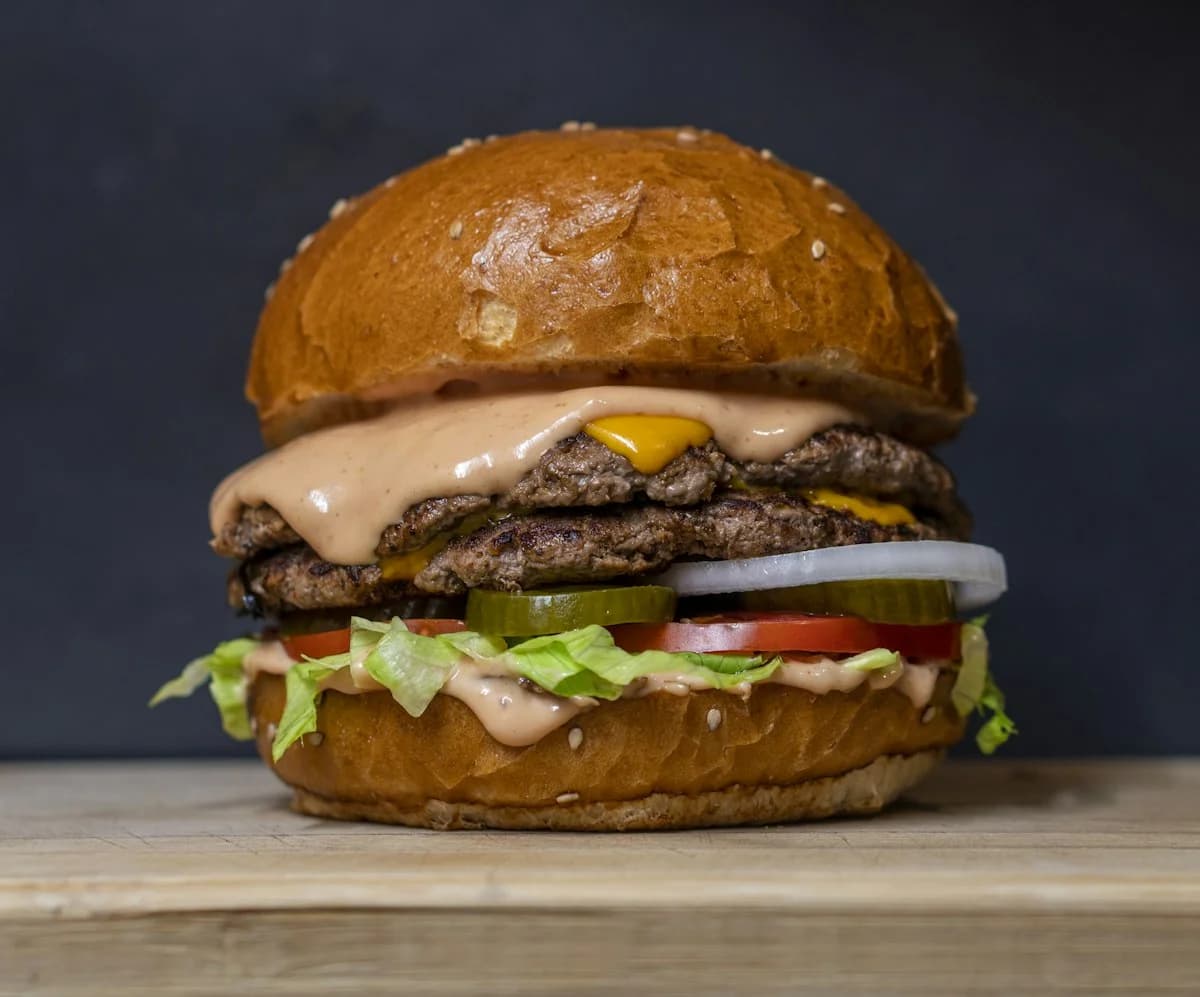 Vegetarian burger with visible bun, crisp patty, and fresh toppings